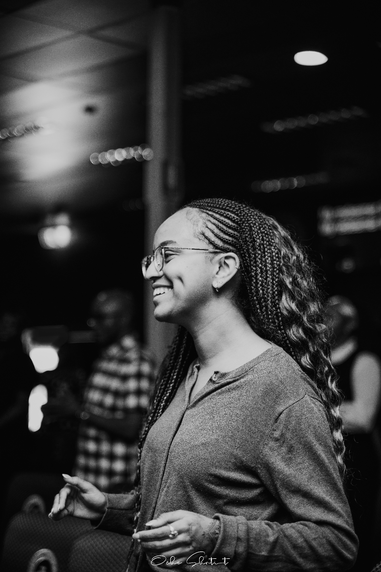 Black and white candid of a speaker laughing during an event