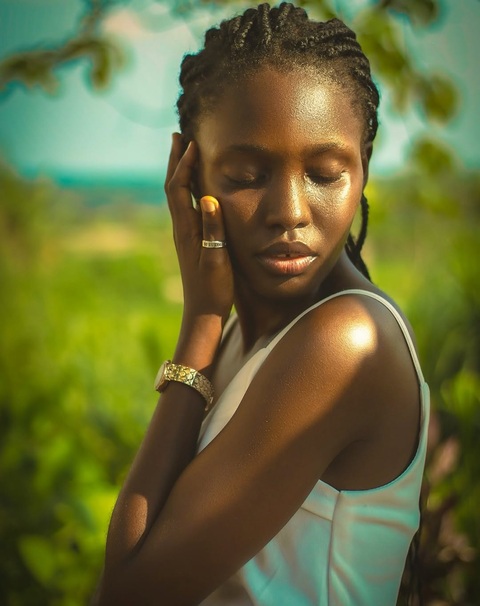 Backlit portrait in an open field at golden hour