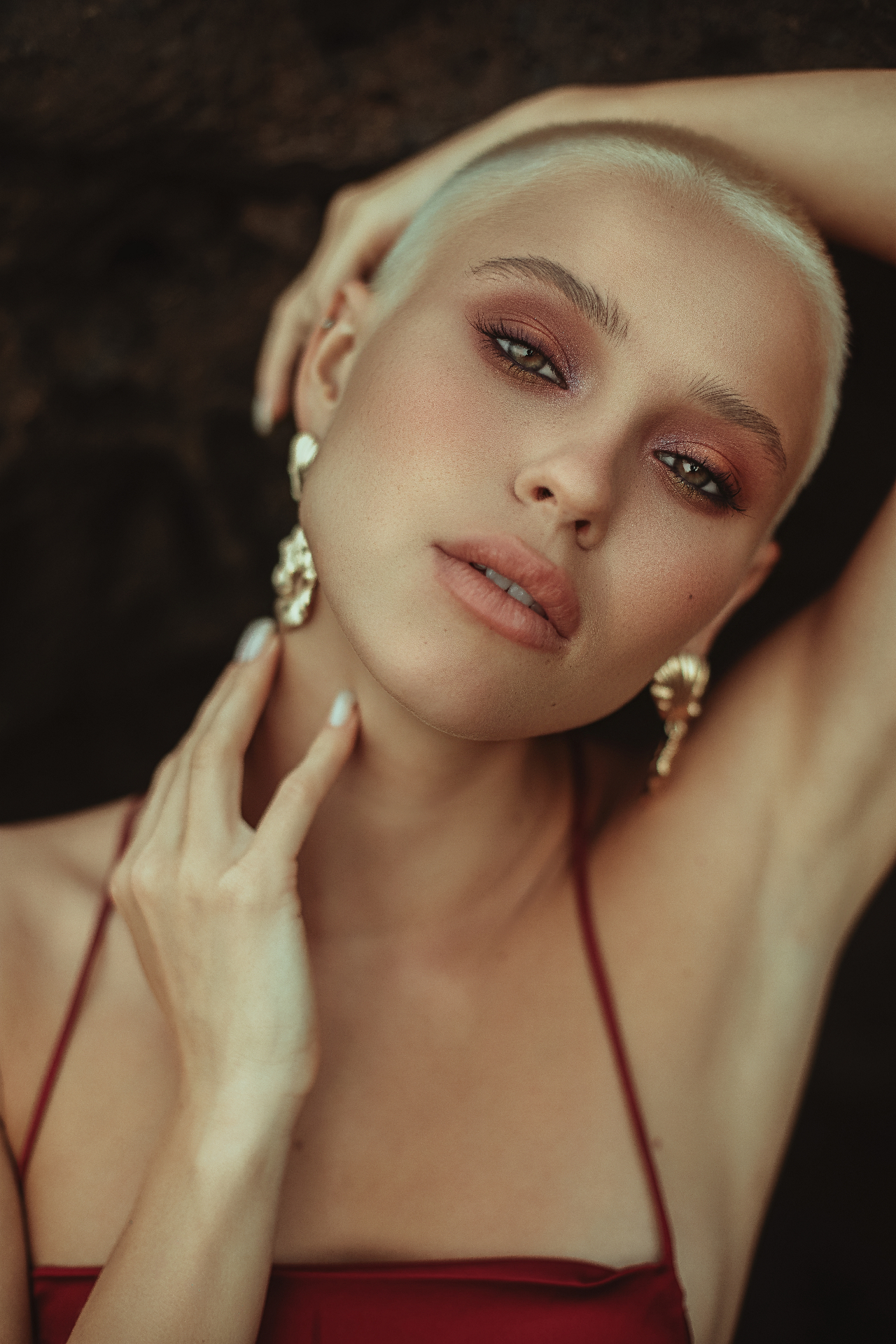 Beauty portrait with gold earrings and warm tones